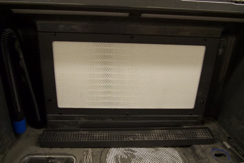 The back panel has a filter inserted with a grate holding it in place