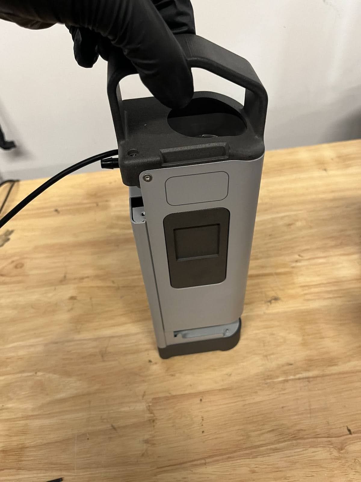 Grip the resin pump by the handle.