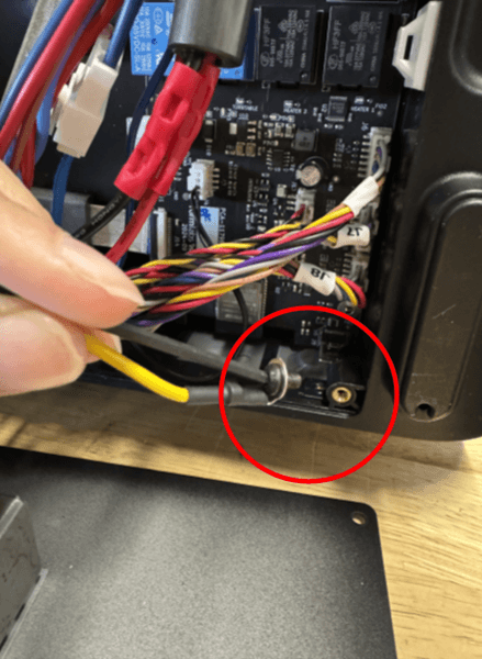 Thread the yellow cable ring terminal through the remaining screw into the lower right corner.