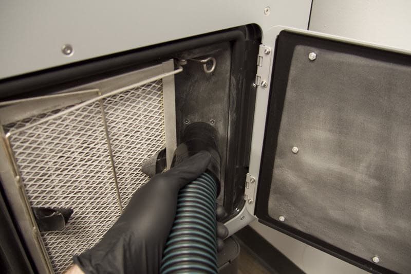 Vacuuming the exhaust port in a Fuse 1 generation printer