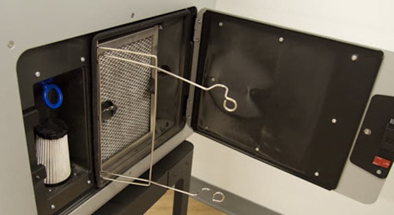 A new exhaust filter is resting in the cabinet