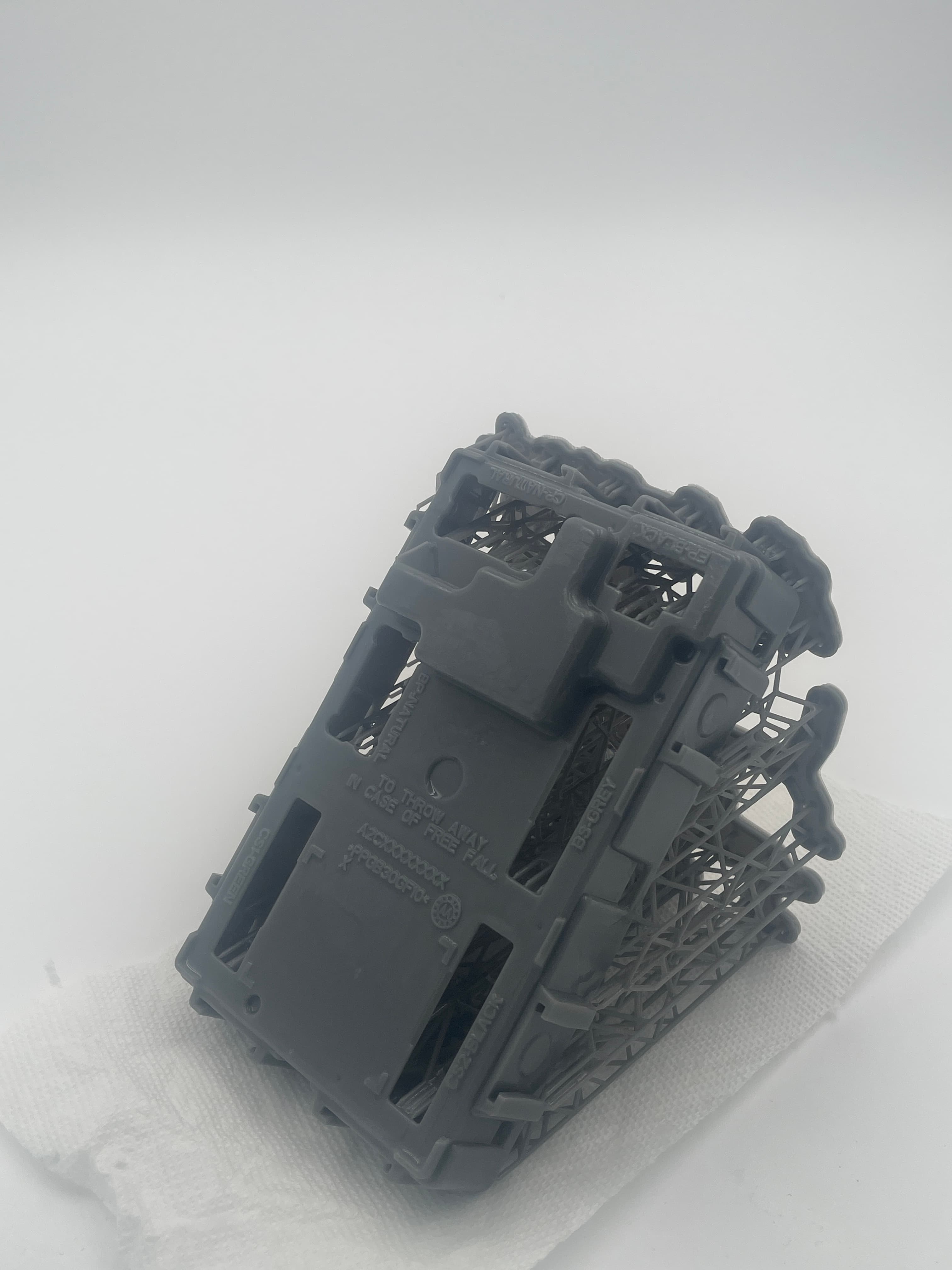 A grey 3D printed part on supports