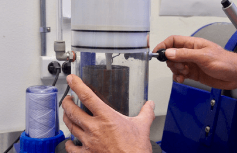 Pouring the investment down the side of the flask.