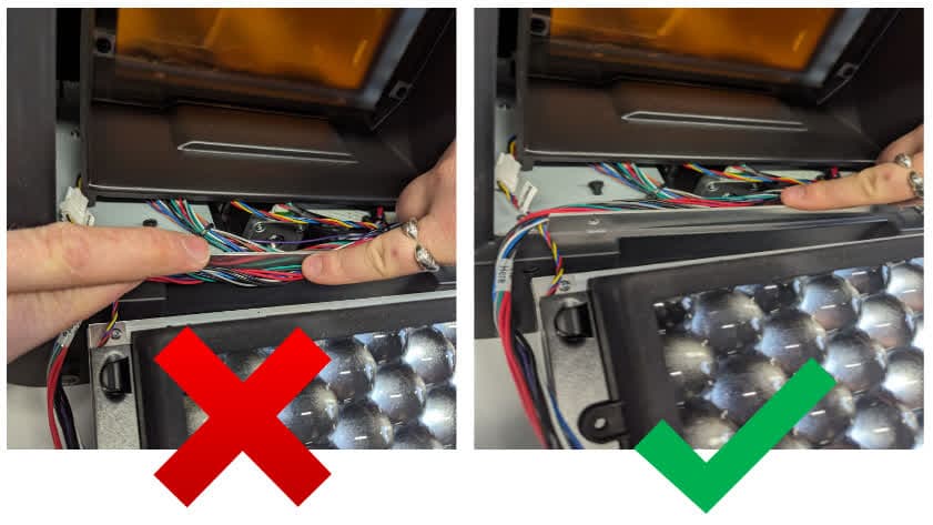 Organizing Form 4 internal cables alongside the metal tab in the optical cavity