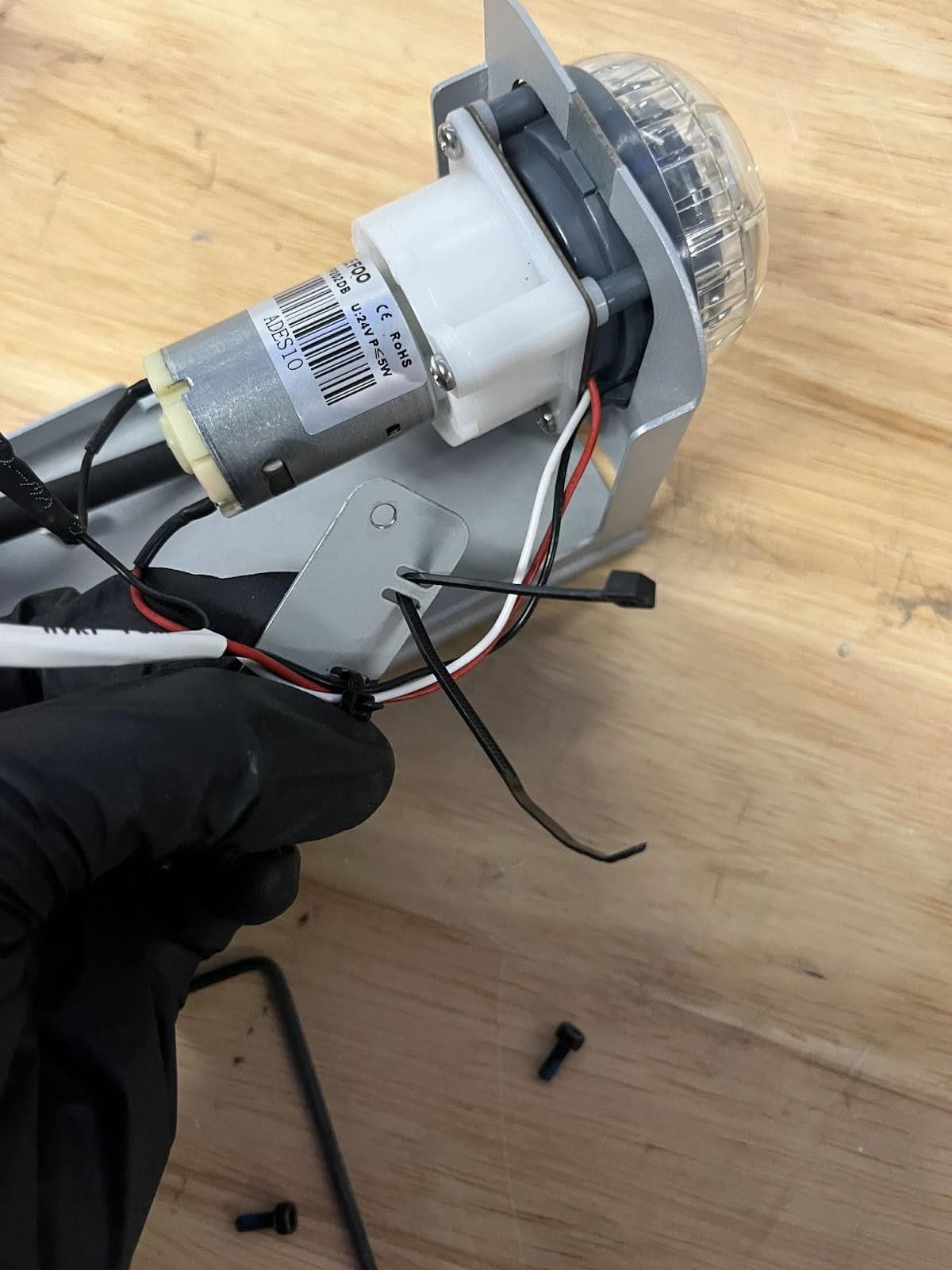 Thread the zip tie through the mounting plate