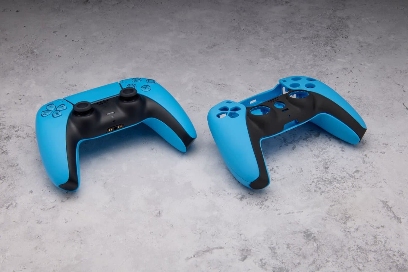 3D printed game controller prototype in Color Resin V5 next to final injection-molded controller