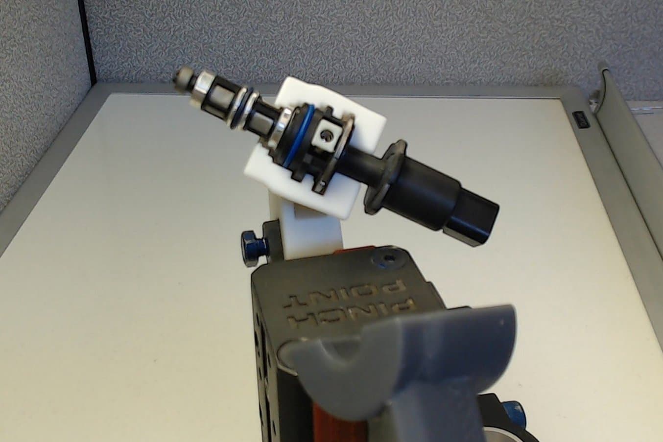 3D printed grippers holding the fuel injector