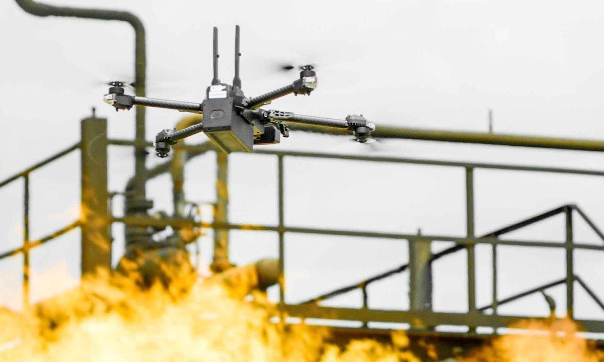 a drone manufactured by Skydio flies above flames