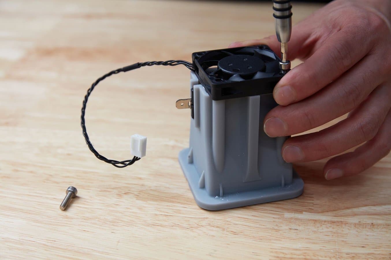 Fastening a fan to the heater holder.