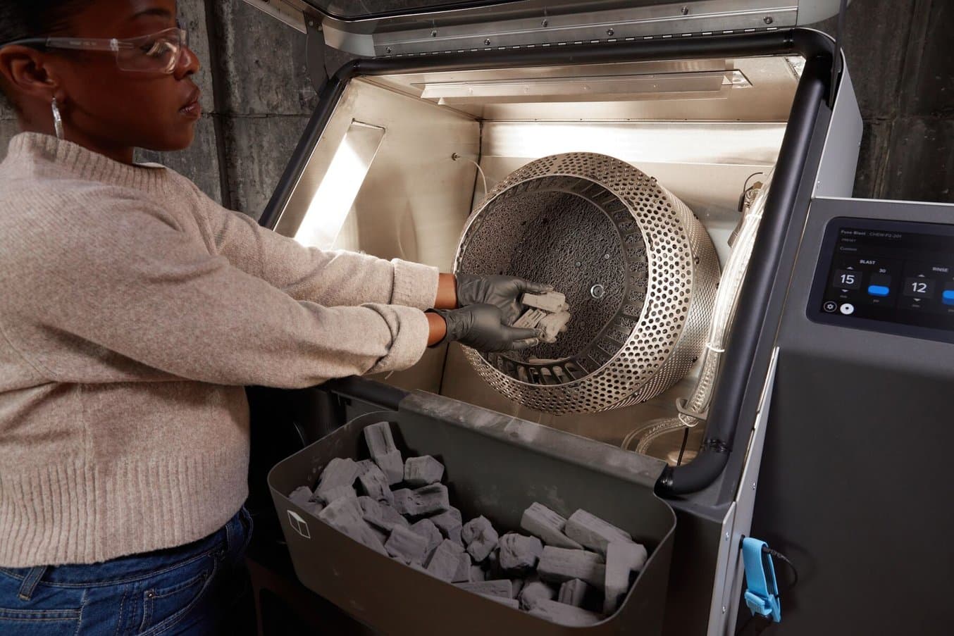 the tumbling basket inside the Fuse Blast gently rotates parts as the blasting nozzle removes powder