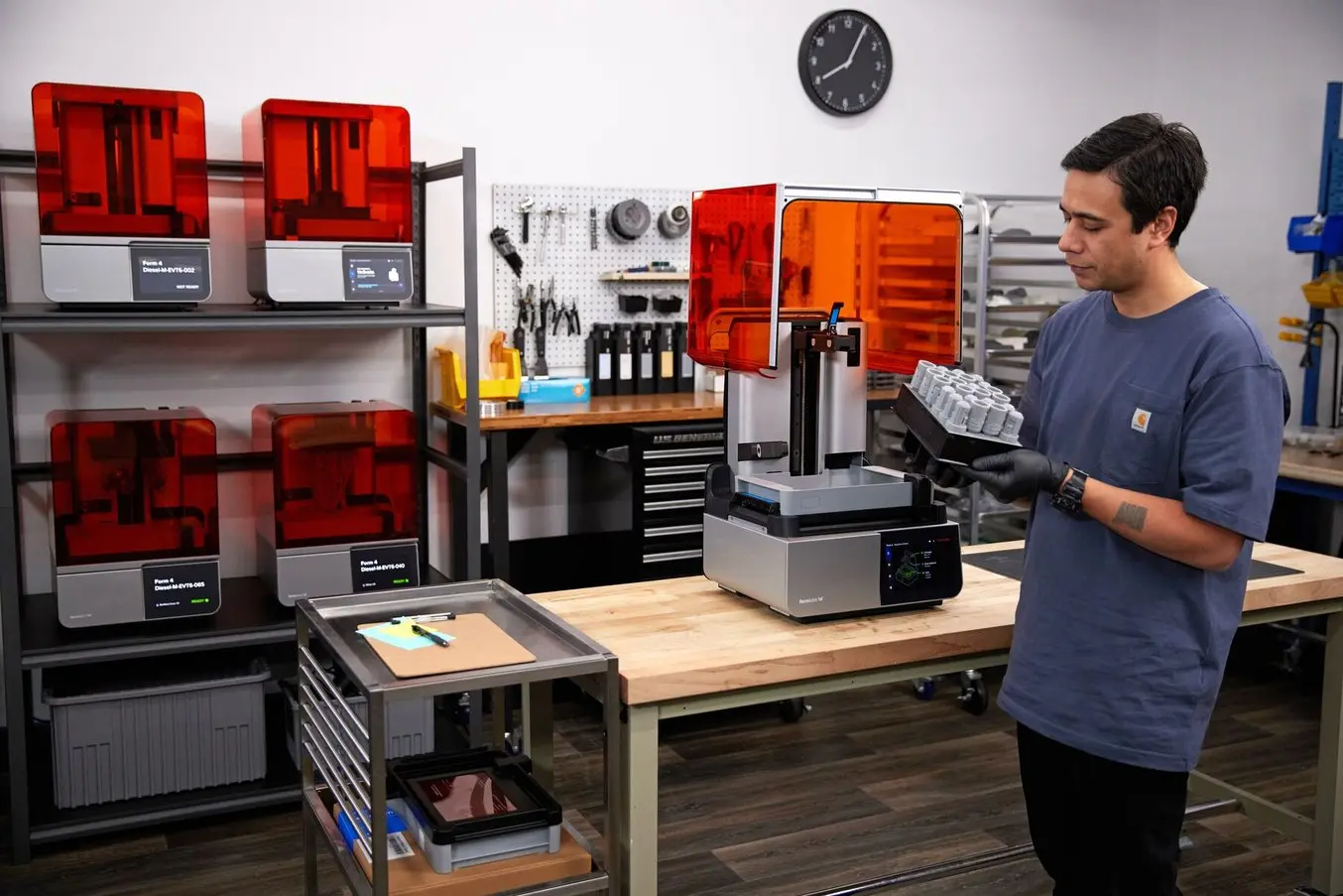 An engineer holding 3D printed parts