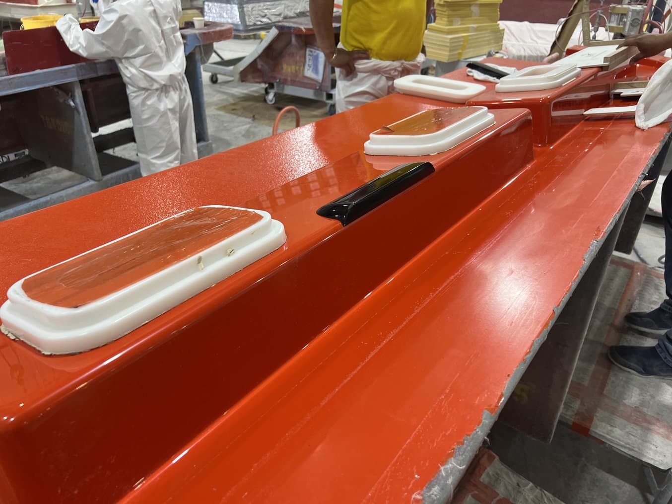 Glossy black part on a red mold