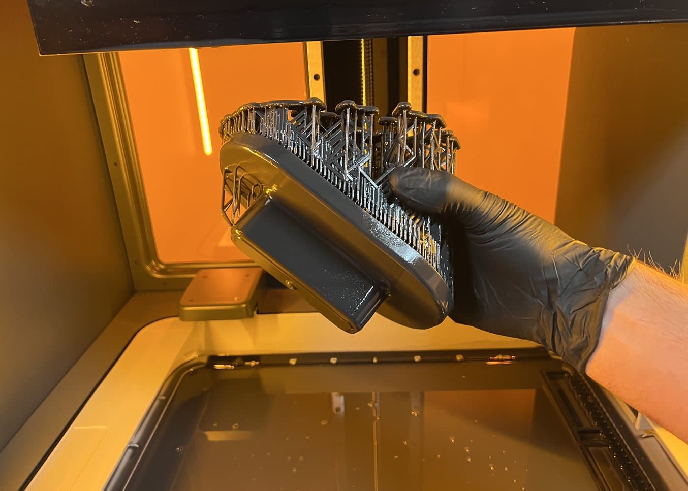 Part inside Form 4L being held with a gloved hand