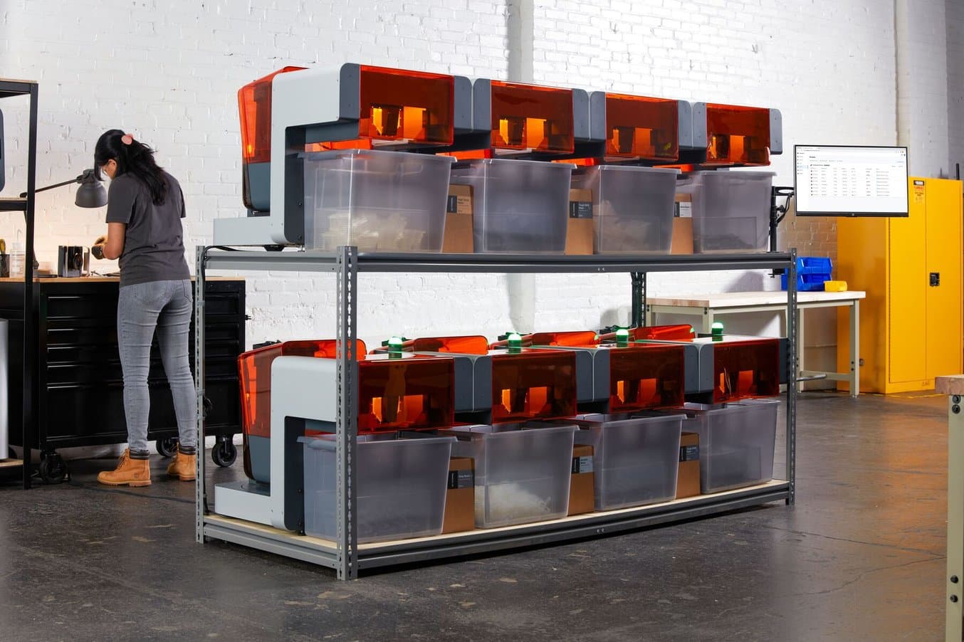 woman engineer stands behind the Formlabs Automation Ecosystem print farm