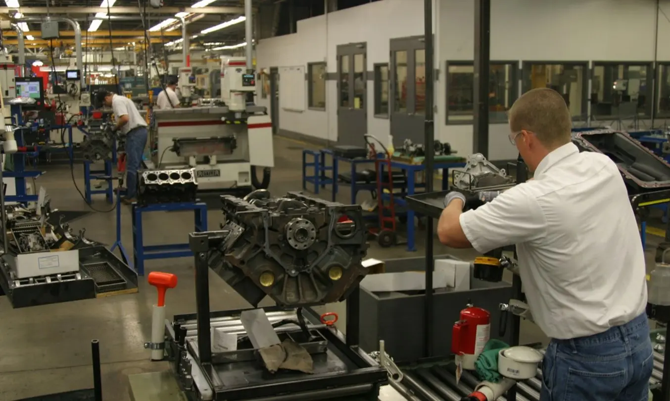 ein Mann arbeitet an einem überholten Motor bei Jasper Engines and Transmissions