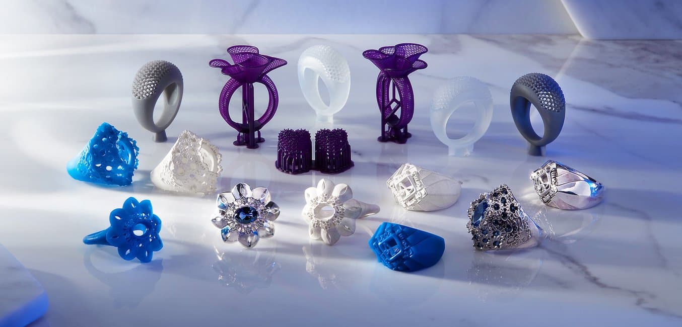 3D printed jewelry patterns and cast metal rings.