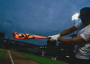 a baseball player swings a baseball bat