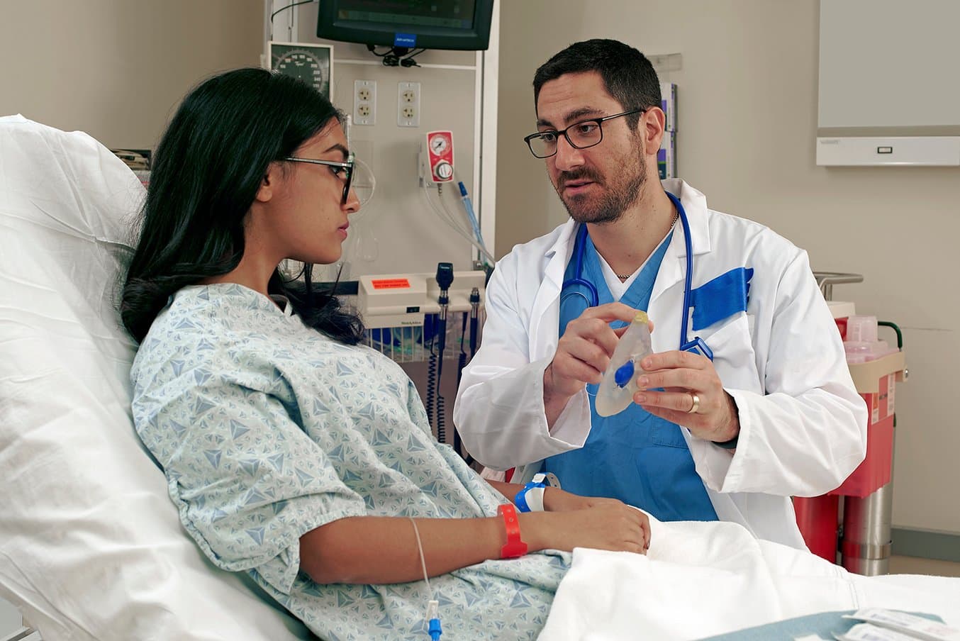 Doctor talking to patient utilizing a 3D printed surgical model