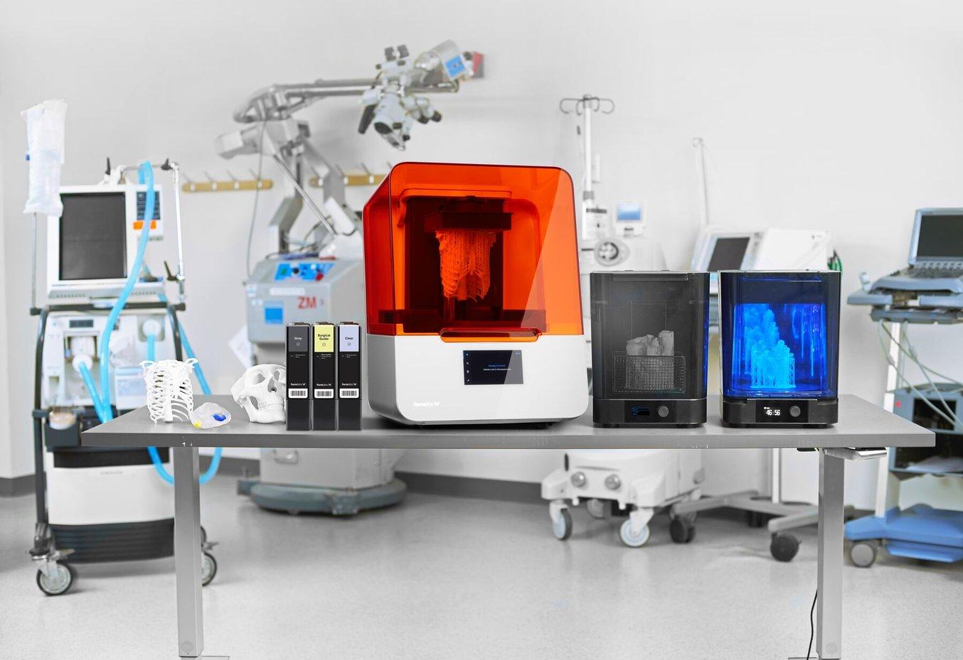Three resin cartridges and a Form 3B printer in a medical setting