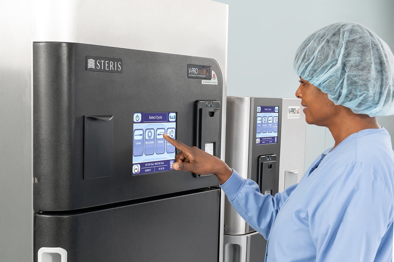 Person in front of V-PRO Low Temperature Sterilizer from STERIS
