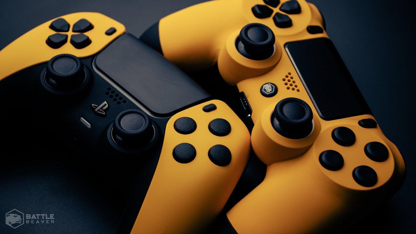 Two yellow gaming controllers on a gray background.