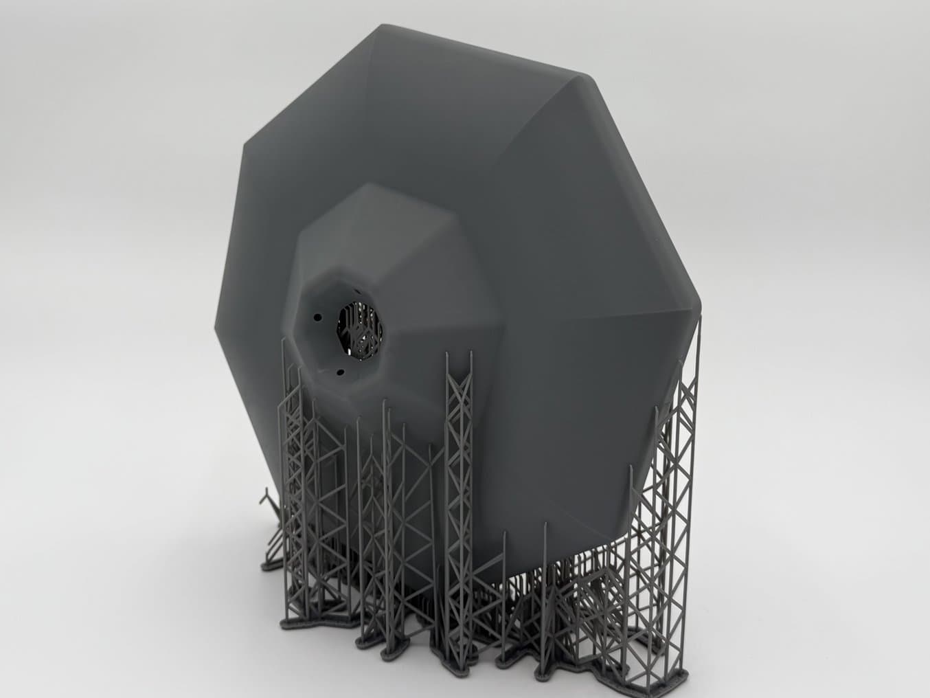 Grey, 3D printed part on supports