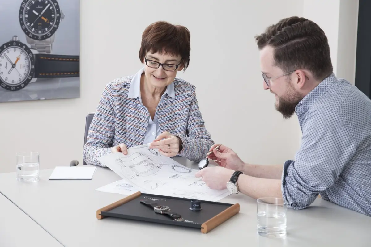 Petra Möller and Nils Hunder comparing the technical drawings with the 3D printed model of a watch.