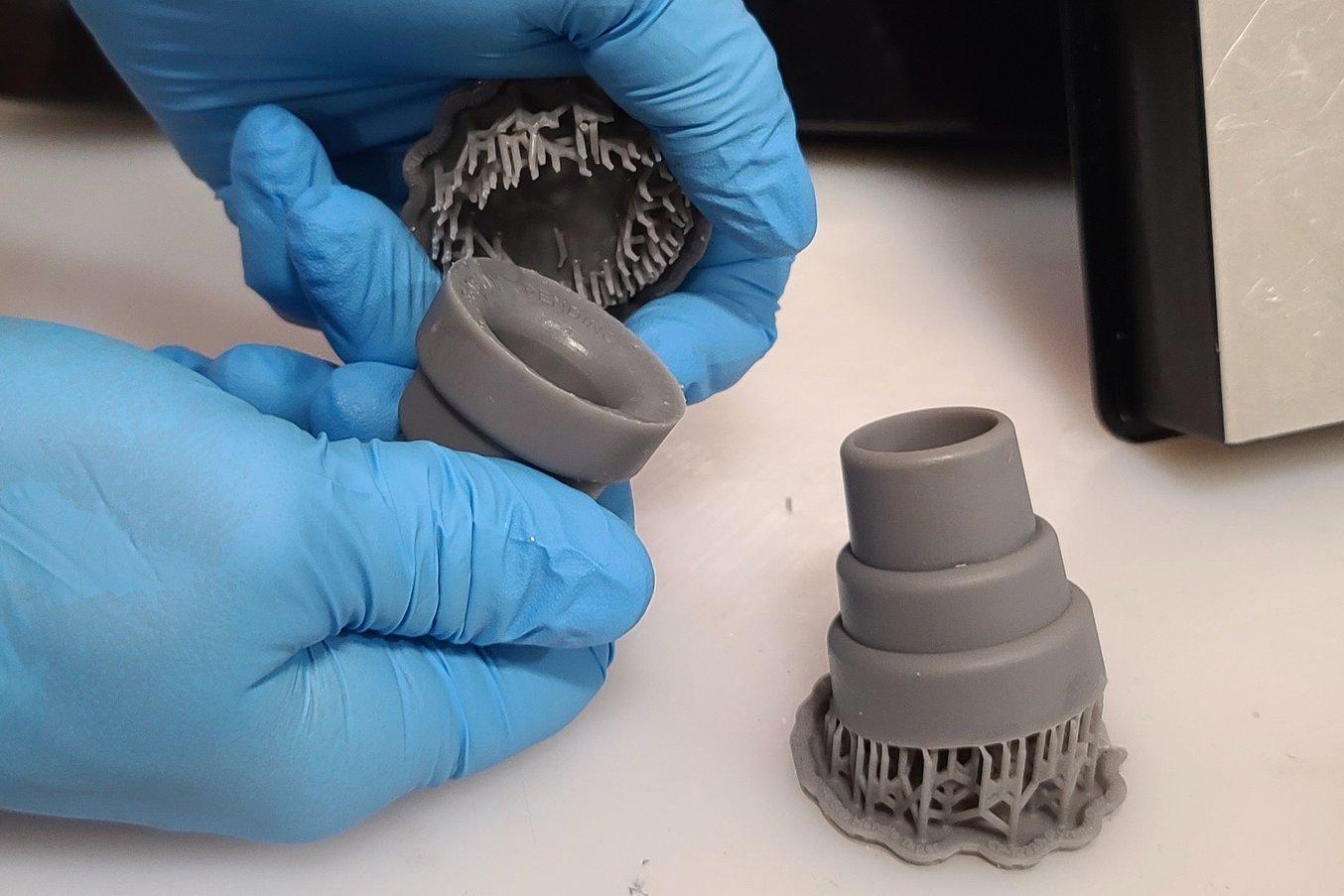 Une personne casse les supports d'un embout imprimé en 3D et prototypé sur la Form 3+