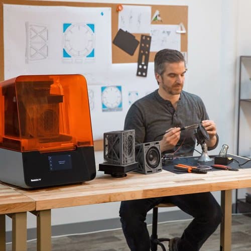 an engineer next to a 3D printer