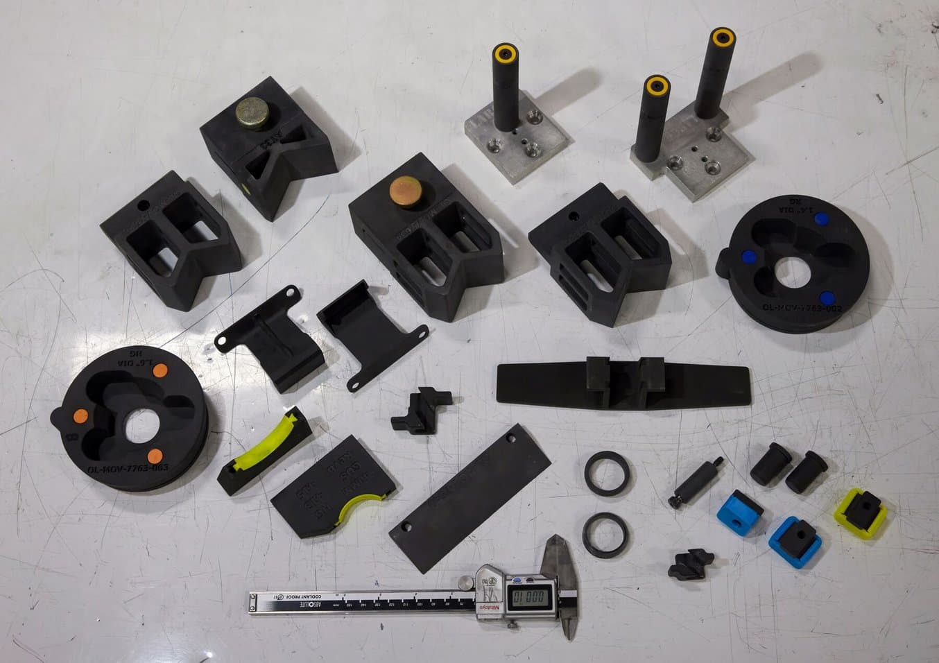 eaton's many 3d printed parts on a white background