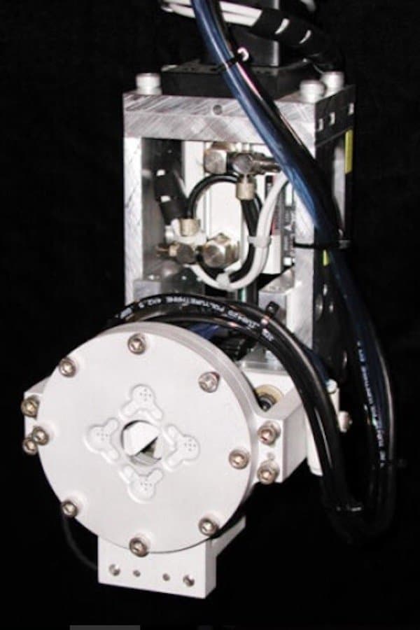 Vacuum Placement end-of-arm-tool for picking up and moving small caps without the use of suction cups.