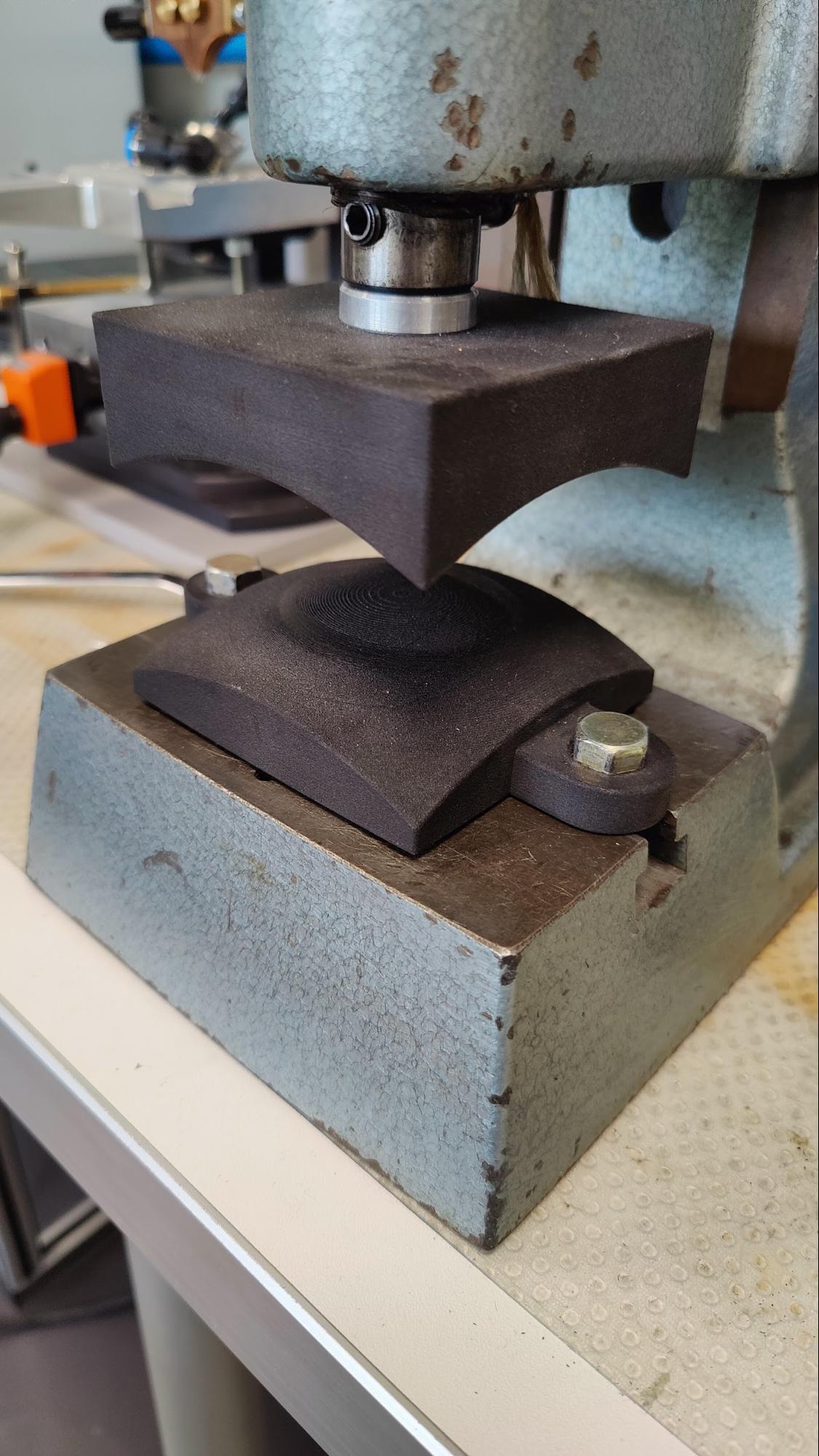 SLS 3D printed Nylon 11 press tool screwed into a toggle press.