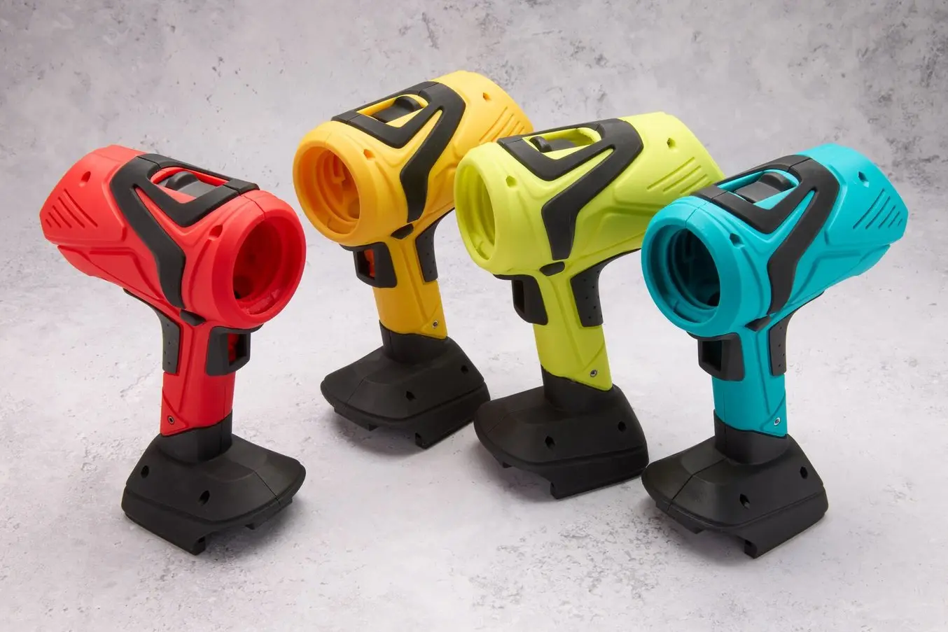 Four 3D printed drill prototypes in various colors