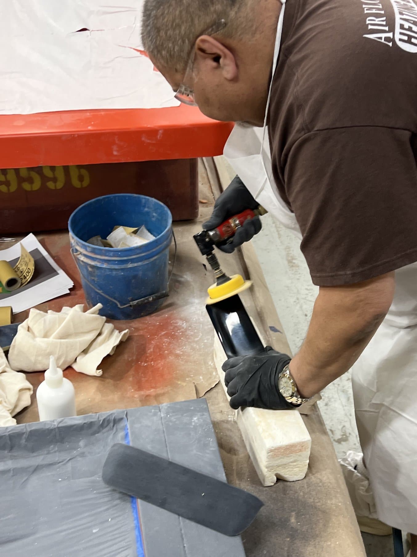 Person using a sander to sand a 3D printed part