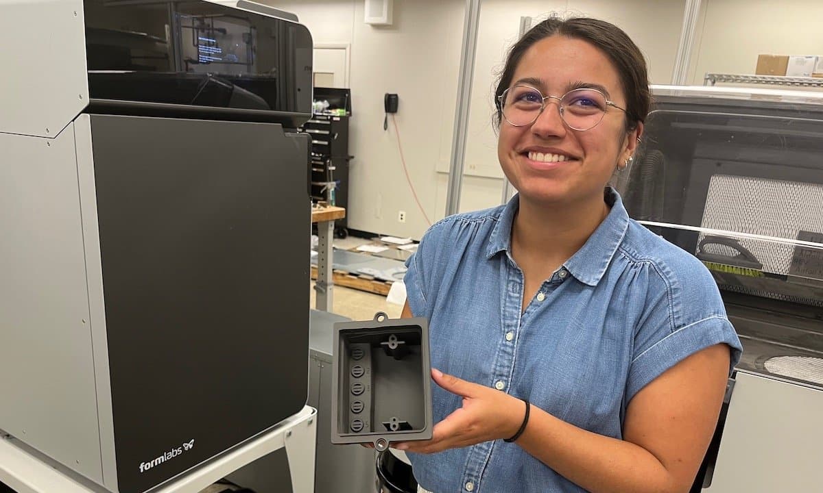 a woman holds a part printed on the Fuse Series SLS 3D Printers at Labconco