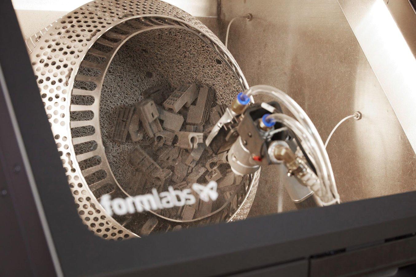 the tumbling basket inside the Fuse Blast gently rotates parts as the blasting nozzle removes powder